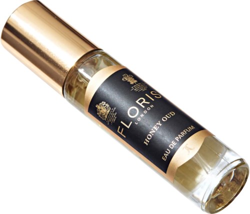 Mała butelka perfumowa z glas, z czarną i złotą etykietą, oznaczona 'HONEY OUD' i 'Eau de Parfum'.