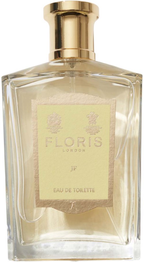 Een heldere parfumfles met een gouden dop en een lichtgele label met 'FLORIS LONDON' en 'EAU DE TOILETTE.'