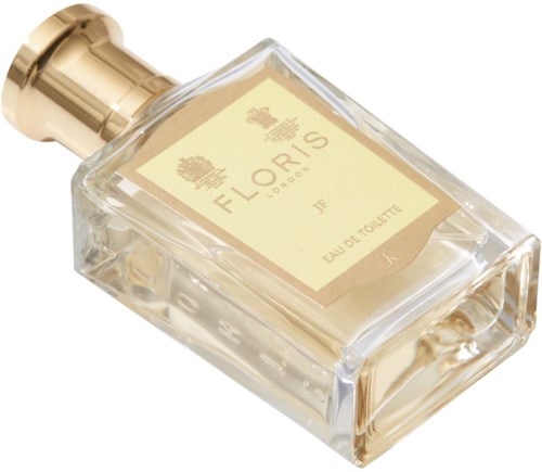 Een doorzichtige parfumfles met gouden details en een beige label met 'Floris London Eau de Toilette.'