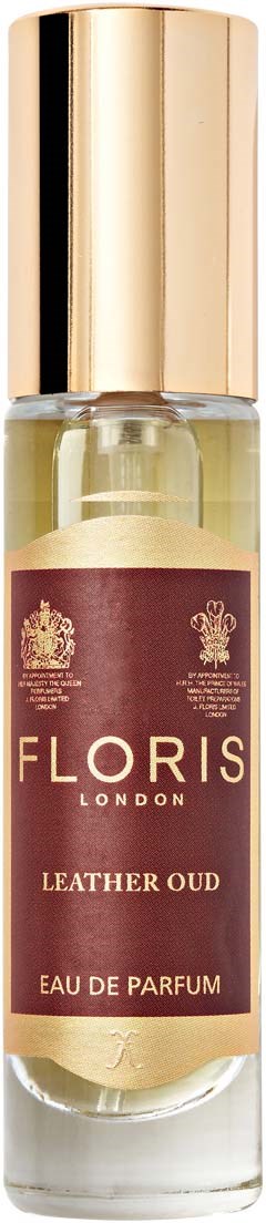 Eine kleine Parfümflasche mit goldener Kappe und braunem Etikett, auf dem "Floriss Leather Oud" steht.