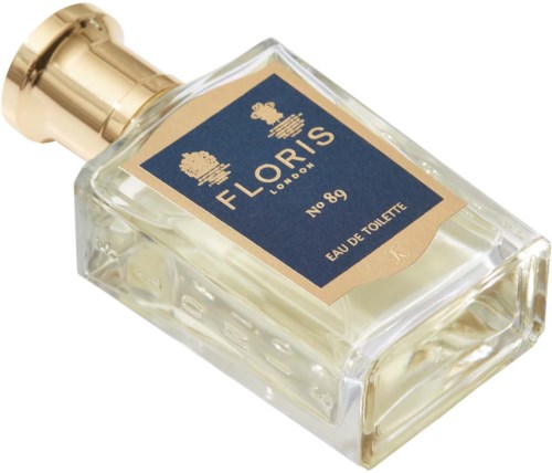 Butelka perfum z etykietą Floris London, No. 89, Eau de Toilette, z złotą zakrętką i ciemnoniebieską etykietą.