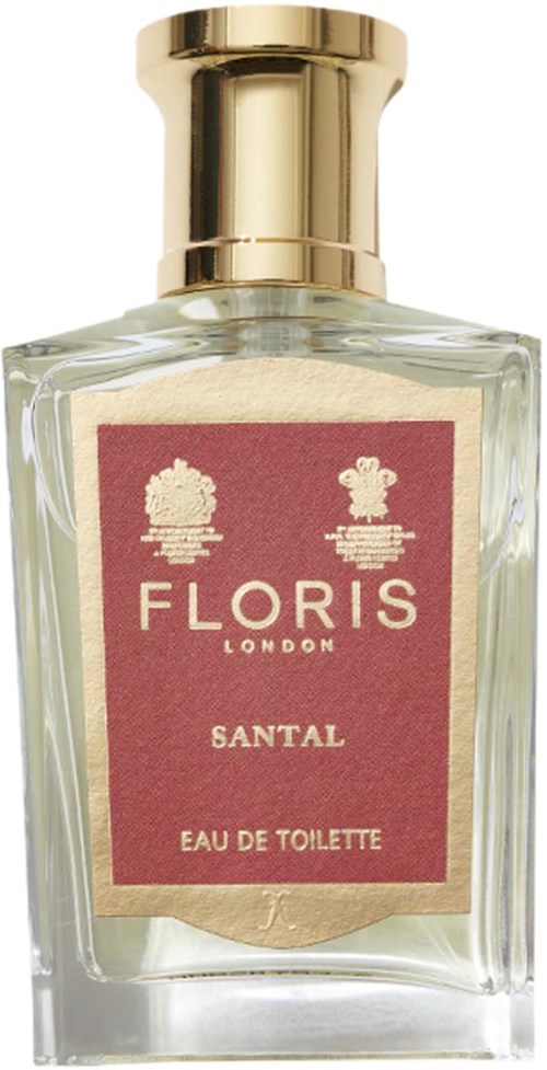 Een duidelijk glazen parfumfles met een gouden dop en een roze label dat zegt 'FLORIS SANTAL Eau De Toilette.'