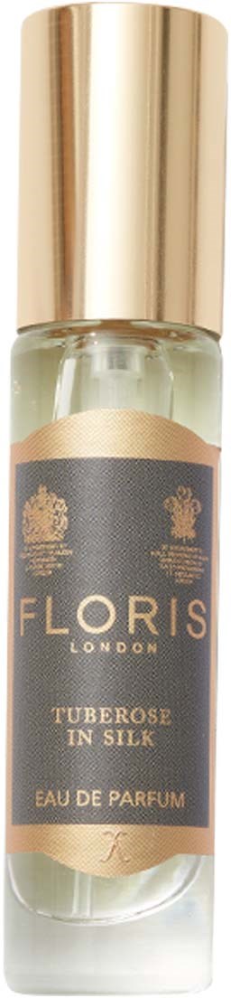 A small perfume bottle with a gold cap and a black label that says Floris London Tuberose in Silk.