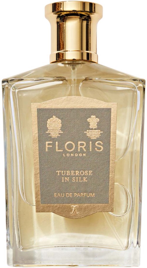 A clear perfume bottle with a gold cap, labeled 'Floris London Tuberose in Silk.'