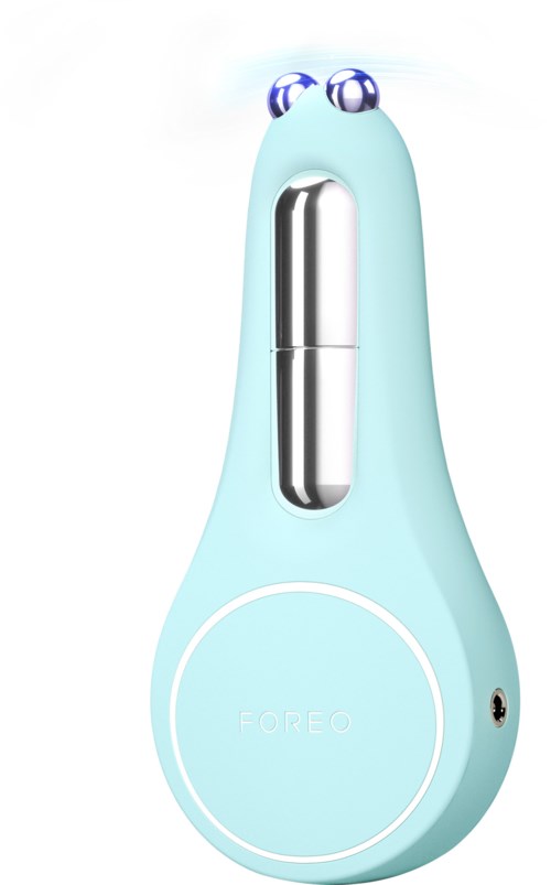Een lichtblauw apparaat met cartoonogen, een zilveren middenstuk en een ronde onderkant gemarkeerd 'FOREO' voor huidverzorging.