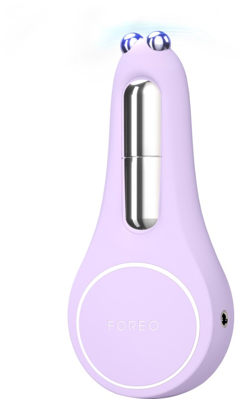 Een paarse apparaat met ogen bovenop, een zilveren deel in het midden en een ronde bodem met 'FOREO' geschreven.