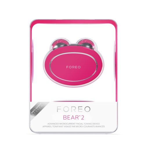 Een roze apparaat in doos, gelabeld 'FOREO BEAR 2,' een gezichtsverstrakker met twee ronde metalen koppen.