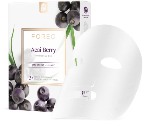 Een doos met FOREO Acai Berry gezichtsmaskers met bosbessenillustratie en een witte gezichtsmasker naast het.