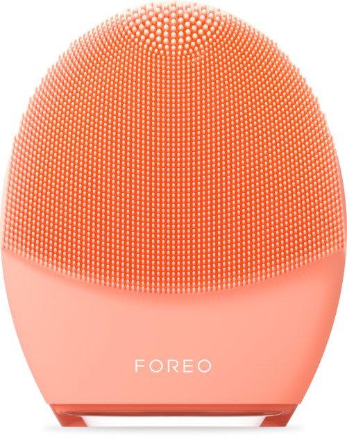 Een roze, ovaalvormig gezichtsreinigingsapparaat met veel kleine borstels en het woord 'FOREO' onderaan.