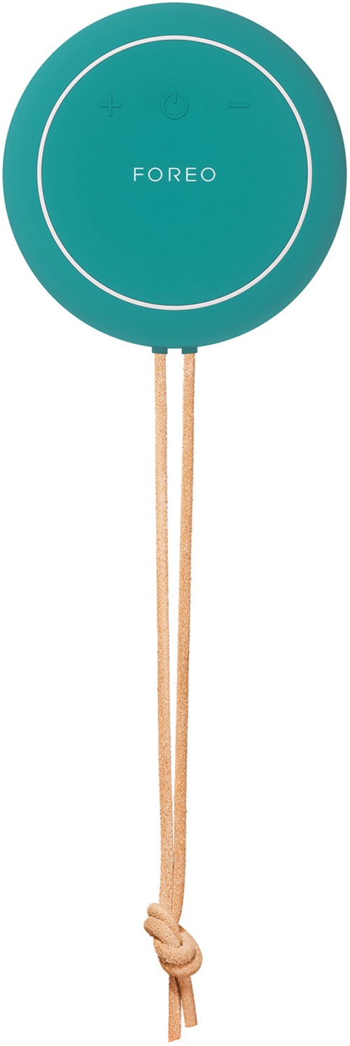 Dit is een teal cirkelvormig apparaat met de merknaam 'FOREO' en een touwtje aan de onderkant. Het lijkt op een schoonmaakgereedschap.