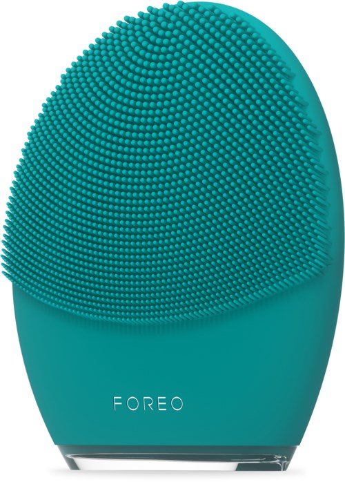 Een teal gekleurde huidverzorgingsapparaat met een getextureerd, stekelig oppervlak en de merknaam 'FOREO' onderaan.