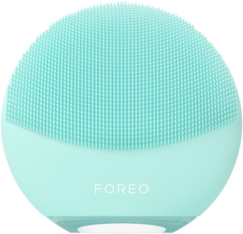 Een ronde, mintgroene apparaat met veel kleine bobbels aan de bovenkant en het woord 'FOREO'.