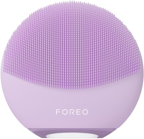 Een paarse, ronde gezichtsreinigingsapparaat met kleine borstelhaartjes bovenaan en "FOREO" onderaan.