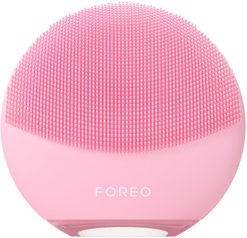 Een roze, ronde gezichtsreinigingsapparaat met veel kleine borstelhaartjes en de merknaam 'FOREO'.