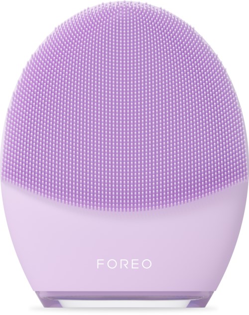 Een roze gezichtsreinigingsborstel met kleine zachte borstels, ronde vorm en de merknaam 'FOREO' erop.