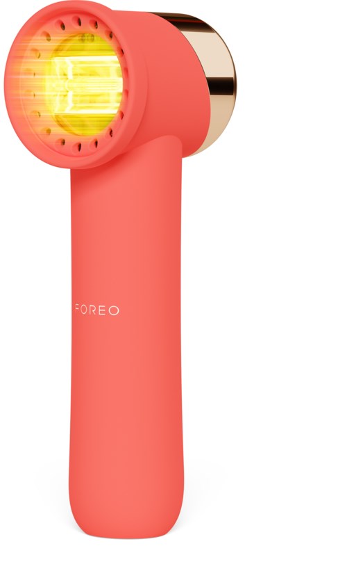 Een roze handbediend apparaat met een gele warmte lamp en een ronde bovenkant, waarschijnlijk een huidverzorgings- of massageapparaat.
