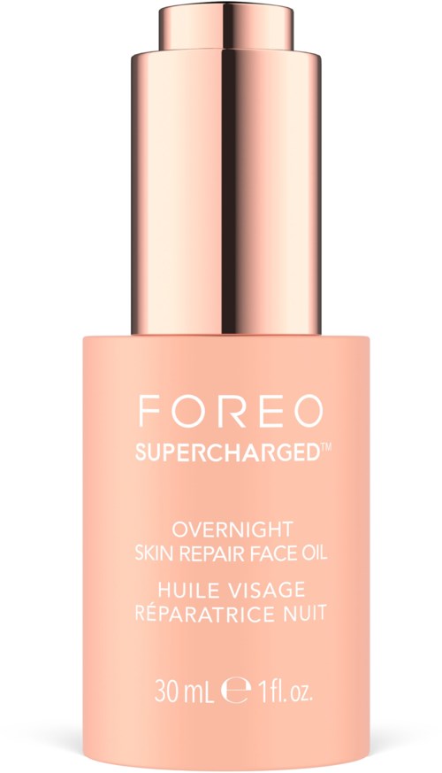 A pink bottle of Foreo Supercharged Overnight Skin Repair Face Oil with a silver cap.