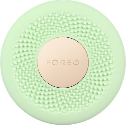 Ronde groene gezichtsreinigingsborstel met zachte borstels en de merknaam 'FOREO' in het midden.