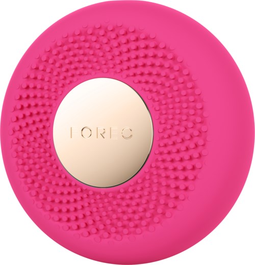 Dit is een roze, ronde gezichtsreinigingsborstel met een zilveren middenstuk waarop 'FOREO' staat.