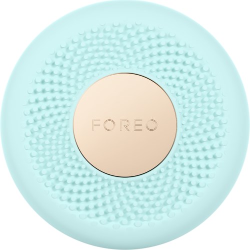 En ljusblå, rund hudvårdsapparat med små knölar runt det centrala området med 'FOREO' inskrivet.