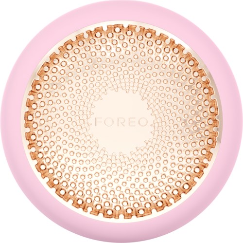 Een ronde apparaat met roze rand en een beige draadgids in het midden, gemarkeerd 'FOREO'.