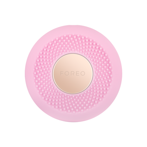 Rundes rosa Schönheitsgerät mit kleinen Erhebungen, mittig beige, mit 'FOREO' bezeichnet.