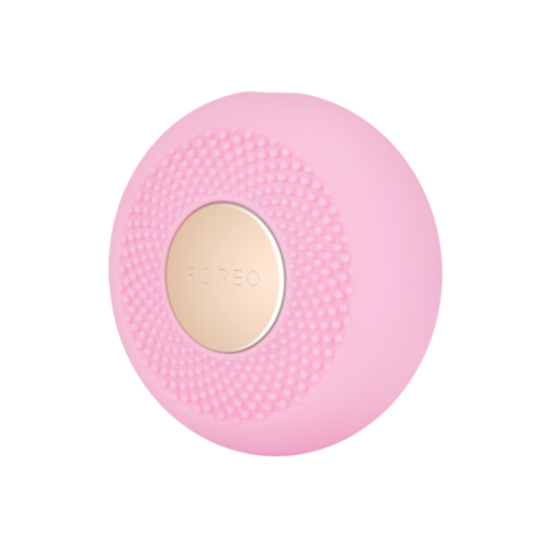 Ein pinker runder Gegenstand mit einem beigen Zentrum, auf dem 'FOREO' steht, und Texturpunkte drumherum.
