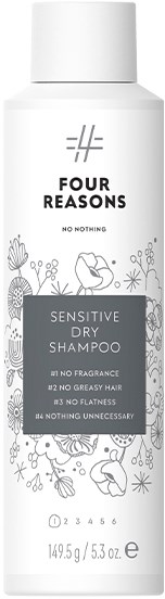 Een witte fles Sensitive Dry Shampoo van Four Reasons, met bloemachtige tekeningen en productclaims.