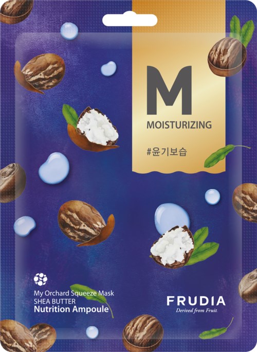 Ett blått förpackning med hasselnötter, gröna blad och vita bubblor. Det är en mask märkt för återfuktning med Shea Butter.