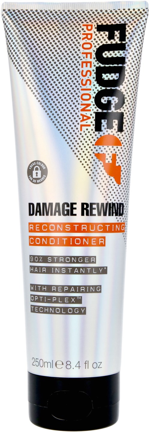 Een tube FUDGE PROFESSIONAL Damage Rewind reconstruërende conditioner met oranje en zwarte tekst op zilver en witte achtergrond.