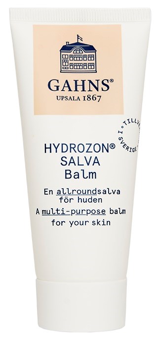 En vit tub med en etikett som visar en byggnadslogga, varumärket GAHNS och text som beskriver det som en mångsidig hudsalva.