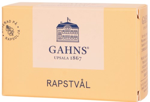 Tvål i en beige förpackning med blå och svart text, visar en byggnad och flagga, kallad "Rapstvål".