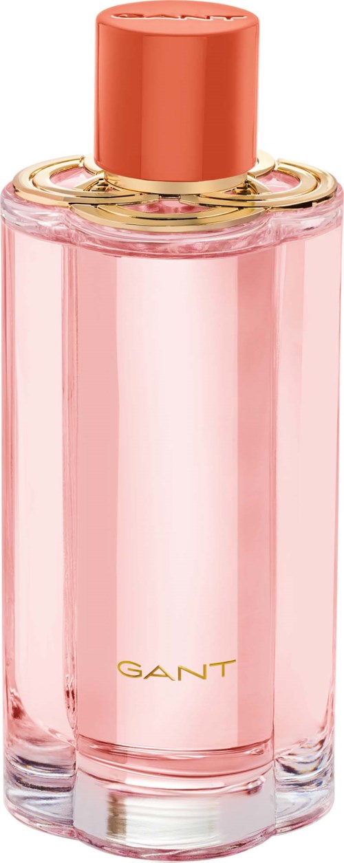 Eine rosa Parfümflasche mit einem goldenen und rosafarbenen Deckel. Das Wort GANT ist unten geschrieben.