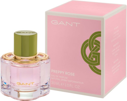 Eine rosa Parfümflasche mit grünem Deckel neben einer rosa Box mit grünem Design, gekennzeichnet GANT Preppy Rose.