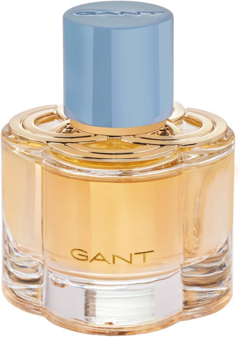Eine Parfümflasche mit blauer Kappe, goldenen Akzenten und dem Namen GANT auf dem Glas.
