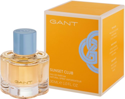 Ein Parfümflasche mit blauer Kappe und gelber Flüssigkeit daneben eine orangefarbene Box mit GANT Sunset Club.
