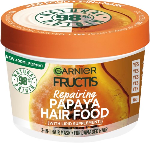 En hårvårdsbehållare i orange, vitt och grönt, märkt Garnier Fructis Repairing Papaya Hair Food.