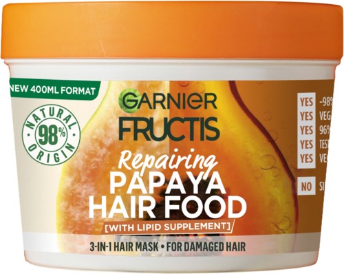 En burk Garnier Fructis Reparining Papaya Hair Food, med orange lock och etikett, för skadat hår.