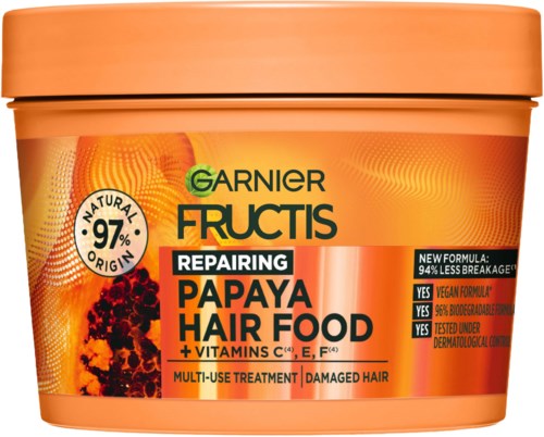 A container of Garnier Fructis Repairing Papaya Hair Food with vitamins, for damaged hair, in bright orange color.