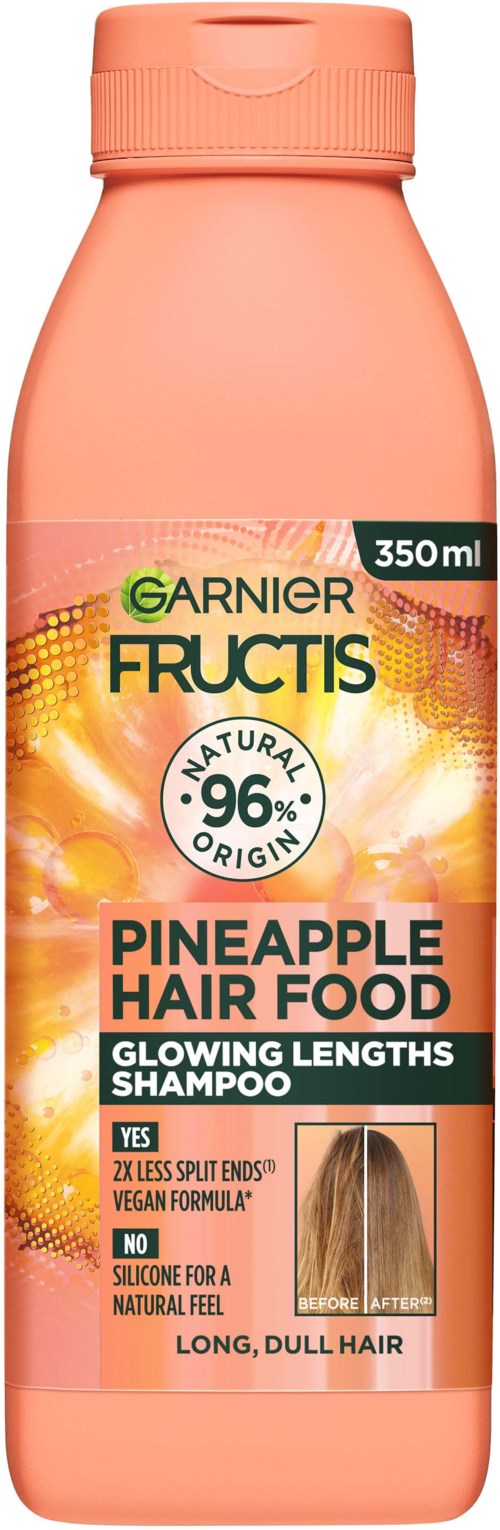 Różowa butelka szamponu Garnier Fructis Pineapple Hair Food z pomarańczową i żółtą etykietą, 350 ml, na długie, matowe włosy.