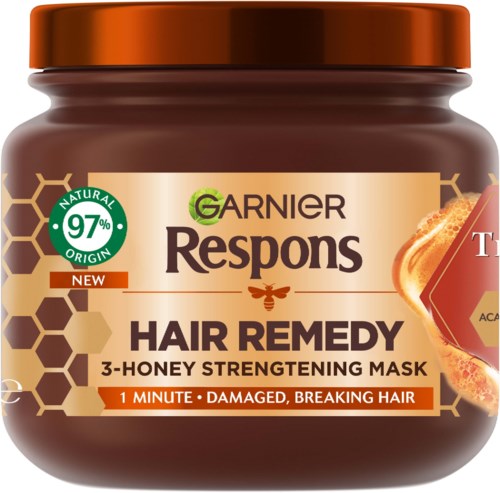 A jar of Garnier Respons Hair Remedy honey hair mask, claiming to repair damaged, breaking hair in one minute.