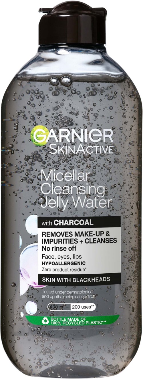 A clear bottle with black cap containing bubbly water, labeled Garnier SkinActive micellar cleansing water with charcoal.