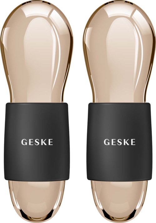 Twee voetmassagetoestellen met zwart band met tekst 'GESKE' en glanzende beige oppervlakken.