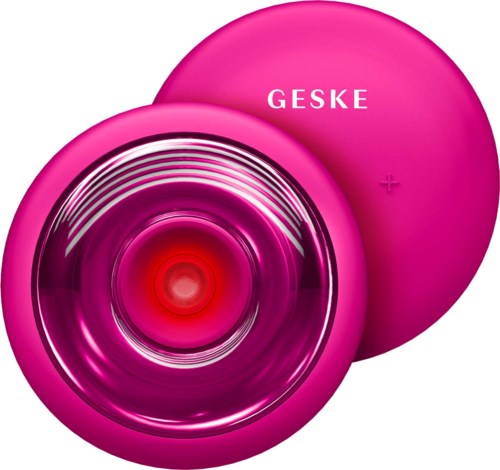 Ein rosa Behälter mit dem Wort 'GESKE' und einem glänzenden, kreisförmigen Deckel oder Spiegel darin.