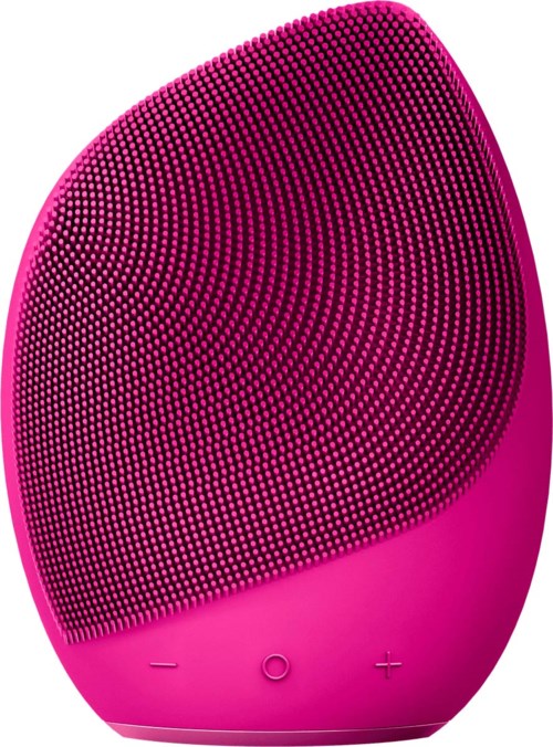 Pink, oval-shaped facial cleansing device with small bristles and buttons for power and volume control.
