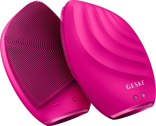 A pink facial cleansing device with a textured side and a smooth side, labeled 'GESKE'.