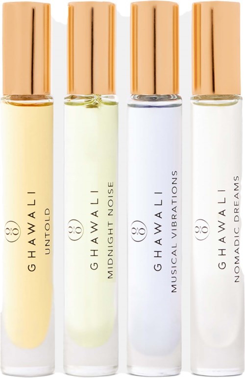 Four perfume bottles with different scents and gold caps, labeled Hawaii, Midnight Noise, Musical Vibrations, and Nonaddic Dreams.