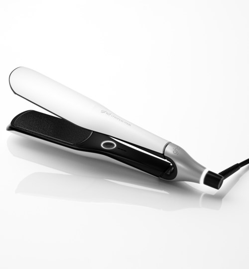 A flat iron with white and black parts used to straighten hair.