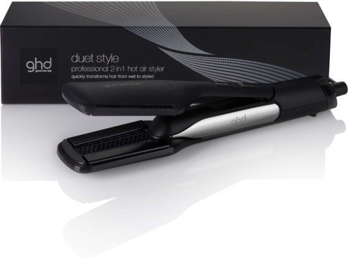 A black and silver hair styling tool with a long handle and flat base, in front of a box.
