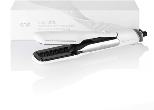 A white hair straightener with black details and a box behind it. The straightener has a digital display and adjustable heat.